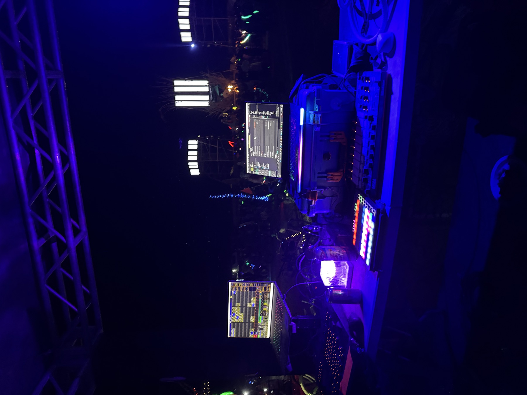 Camp Questionmark Burning Man FOH visual control setup with laptops, MIDI controllers, and crowd in the distance