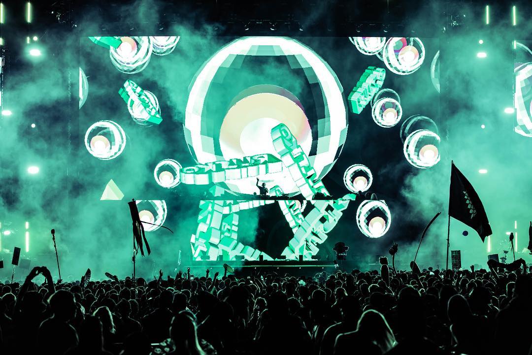 Wide crowd view of Rusko's green live visual treatment