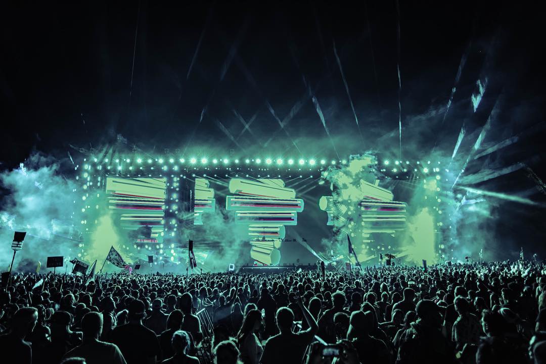 Rusko stage look with smoke and green geometric content