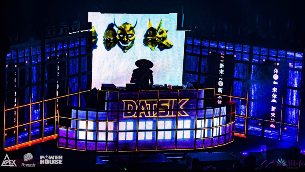 Datsik silhouetted at the Shogun Stage with masks and blue LED architecture