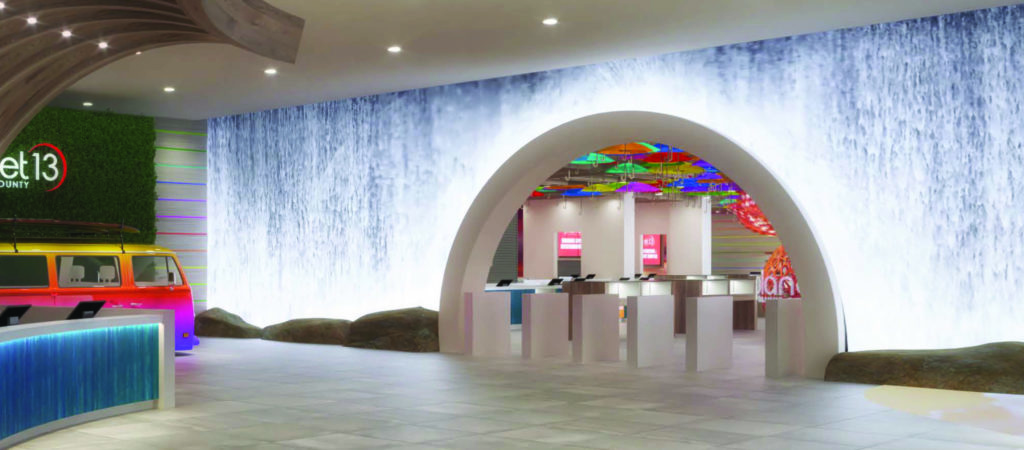 Wide view of the Planet 13 lobby with waterfall LED wall and themed VW van