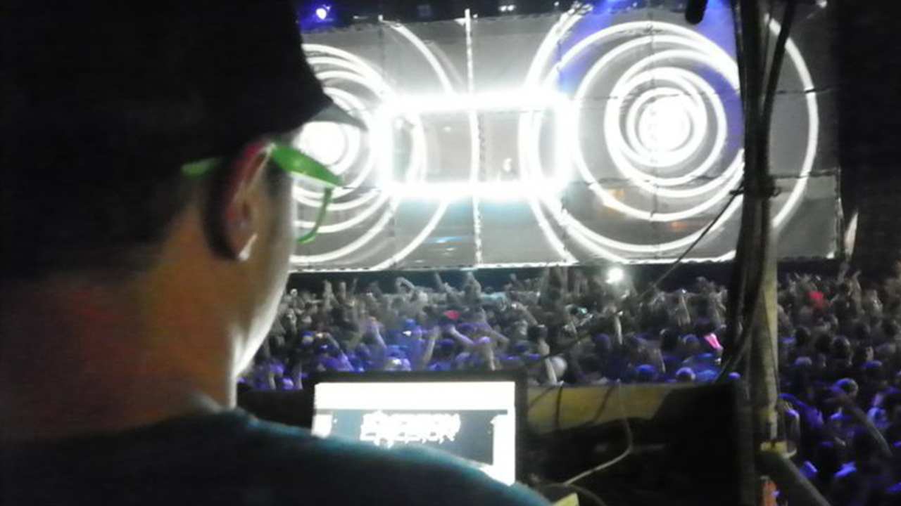 View from projection control toward the Tower of Babel crowd and mapped facade
